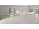 Bright and airy living room featuring tile floors and a expansive mirror wall with an archway at 1200 N Shore Ne Dr # 102, St Petersburg, FL 33701