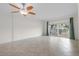 Large living room with tile floors and sliding glass doors to a private balcony with an outside view at 1200 N Shore Ne Dr # 102, St Petersburg, FL 33701