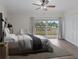Comfortable main bedroom featuring a ceiling fan, closet and sliding glass door to an outdoor balcony at 1200 N Shore Ne Dr # 102, St Petersburg, FL 33701
