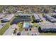 Aerial view of community featuring well-maintained buildings, a serene pond, and sparkling community pool at 12709 Raeburn Way, Tampa, FL 33624