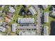 Bird's-eye view showcasing the layout of community buildings, parking, and a scenic pond at 12709 Raeburn Way, Tampa, FL 33624