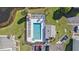 Aerial view of a sparkling community pool with surrounding amenities and manicured landscaping at 12709 Raeburn Way, Tampa, FL 33624