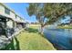 Scenic backyard view overlooking a tranquil pond with a fountain and a screened-in patio at 12709 Raeburn Way, Tampa, FL 33624