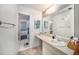 Bright bathroom featuring sink and vanity, with decor accents and a view into bedroom at 12709 Raeburn Way, Tampa, FL 33624