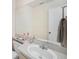 Neutral bathroom featuring a white sink, light countertop, and large mirror at 12709 Raeburn Way, Tampa, FL 33624