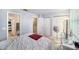 Bedroom featuring bright walls, white furniture, and double closets at 12709 Raeburn Way, Tampa, FL 33624