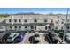 Aerial view of townhome complex with ample parking and well-maintained landscaping on a bright, sunny day at 12709 Raeburn Way, Tampa, FL 33624
