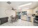 Functional kitchen features modern appliances and an adjacent dining area with screened patio access at 12709 Raeburn Way, Tampa, FL 33624