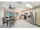 Well-equipped kitchen with stainless steel appliances and a dining area with a pond view at 12709 Raeburn Way, Tampa, FL 33624