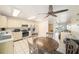 Bright kitchen with stainless steel appliances open to the living and dining areas at 12709 Raeburn Way, Tampa, FL 33624