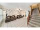 Bright living room boasts neutral tile floors and stairs leading to the upper level at 12709 Raeburn Way, Tampa, FL 33624