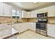 Modern kitchen featuring white cabinetry, stainless steel appliances, and stone countertops at 1300 Farragut N Dr, St Petersburg, FL 33710