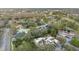 Aerial view showcasing the neighborhood, mature trees, a golf course, and the property's roof at 13502 Palmwood Ln # 13502, Tampa, FL 33618