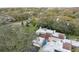 An aerial view of the property showing the roof line, trees and surrounding area at 13502 Palmwood Ln # 13502, Tampa, FL 33618