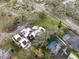 Overhead view of homes, some with pools, nestled in a mature landscape near a golf course at 13502 Palmwood Ln # 13502, Tampa, FL 33618