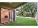 This backyard features artificial turf and a sliding glass door at 13502 Palmwood Ln # 13502, Tampa, FL 33618