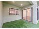 This backyard features artificial turf and multiple sliding glass doors at 13502 Palmwood Ln # 13502, Tampa, FL 33618