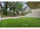 Well-maintained backyard features artificial turf and an outdoor living space at 13502 Palmwood Ln # 13502, Tampa, FL 33618