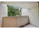 Private outdoor balcony space with view of mature landscaping and blue sky at 13502 Palmwood Ln # 13502, Tampa, FL 33618