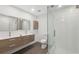 Modern bathroom features a double sink vanity, sleek fixtures, and a glass-enclosed shower with tiled walls at 13502 Palmwood Ln # 13502, Tampa, FL 33618