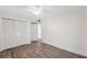 Comfortable bedroom features natural light, wood-look flooring, and a closet with paneled doors at 13502 Palmwood Ln # 13502, Tampa, FL 33618