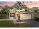 Charming two-story townhome with attached garage and vibrant landscaping at 13502 Palmwood Ln # 13502, Tampa, FL 33618