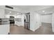 Modern kitchen with stainless steel appliances and sleek white cabinets and adjacent hallway entrance at 13502 Palmwood Ln # 13502, Tampa, FL 33618