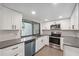 Bright kitchen with stainless steel appliances, gray backsplash and a large window above the sink at 13502 Palmwood Ln # 13502, Tampa, FL 33618