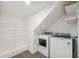 Bright laundry room features a modern washer and dryer set and white wire shelving for convenient storage solutions at 13502 Palmwood Ln # 13502, Tampa, FL 33618