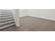 Spacious living room area with tile floors and stairs to the second floor at 13502 Palmwood Ln # 13502, Tampa, FL 33618