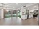 Open living room and kitchen with stainless steel appliances, gray backsplash and a lovely backyard view at 13502 Palmwood Ln # 13502, Tampa, FL 33618