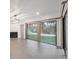 Bright living room with modern lighting fixtures and large sliding glass doors with a view of the yard at 13502 Palmwood Ln # 13502, Tampa, FL 33618
