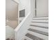 Crisp, modern staircase with white risers and stained treads ascending to the next level of the residence at 13502 Palmwood Ln # 13502, Tampa, FL 33618