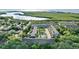 Aerial view showcasing the property's proximity to waterways and lush greenery at 14 Seagrape Cir, Clearwater, FL 33759