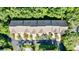 Aerial view of townhomes with well maintained landscaping, pool, and ample parking at 14 Seagrape Cir, Clearwater, FL 33759