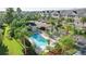 Aerial shot of community pool nestled between palm trees and townhomes at 14 Seagrape Cir, Clearwater, FL 33759