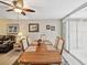 Bright dining room with a large wooden table, seating for six, and a sliding glass door to the kitchen at 1433 S Belcher Rd # F20, Clearwater, FL 33764