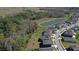 Aerial view of homes within a community, some bordering a peaceful pond at 17953 Ramble On Way, Land O Lakes, FL 34638