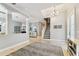 Bright foyer showcasing travertine floors, an open staircase, a dining room, and lots of natural light at 18014 Forest Retreat Ln, Tampa, FL 33647