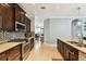 Open kitchen layout with stylish cabinetry, stainless appliances, and an open view to the dining area at 18014 Forest Retreat Ln, Tampa, FL 33647