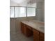 Bathroom featuring a double sink vanity, large mirror, and a separate shower at 19432 Haskell Pl, Land O Lakes, FL 34638