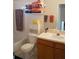 Functional bathroom with a combination tub and shower, storage cabinet, and vanity with sink at 19432 Haskell Pl, Land O Lakes, FL 34638