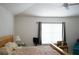 Bedroom with a bed, a side table, a chair and a window at 19432 Haskell Pl, Land O Lakes, FL 34638