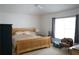 Bright bedroom with a ceiling fan, window, bed and a chair at 19432 Haskell Pl, Land O Lakes, FL 34638