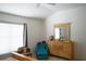 Bedroom with a dresser with a mirror, a chair, and a window at 19432 Haskell Pl, Land O Lakes, FL 34638