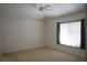 Bedroom with a large window, neutral walls, and carpeted floors at 19432 Haskell Pl, Land O Lakes, FL 34638