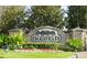 Stone sign for the Oakstead community surrounded by manicured landscaping and lush greenery at 19432 Haskell Pl, Land O Lakes, FL 34638