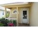 Close up of a quaint front porch, showcasing decorative details and well maintained bushes at 19432 Haskell Pl, Land O Lakes, FL 34638