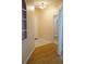 Hallway with a mix of tile and wood flooring leading to the bathroom and other rooms at 19432 Haskell Pl, Land O Lakes, FL 34638