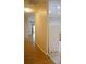 Open floor plan with wood flooring next to a wall near the kitchen, featuring a white refrigerator at 19432 Haskell Pl, Land O Lakes, FL 34638